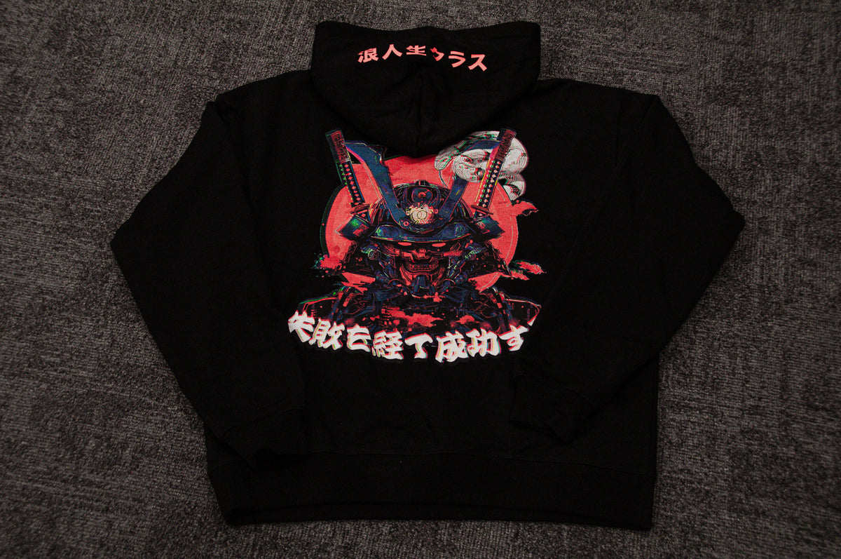 An oversized black hooded sweatshirt from Incompletegl is laid flat on a dark carpet. The back showcases vibrant, intricate artwork of a samurai in traditional armor beneath a red moon, accented by Japanese characters above and below the image. This Mecha Ronin | Oversized Hoodie effortlessly fuses traditional motifs with cyberpunk elements for an eye-catching design.