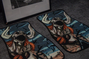 Two matching floor mats, showcasing a striking design of a formidable creature with prominent horns and flowing red hair, infuse an anime-themed vibe into the room. Set atop a gray carpet beside a partially visible framed picture, they capture the allure found in Incompletegl's "Bleach Mega Mystery! | Anime Bundle Pack.