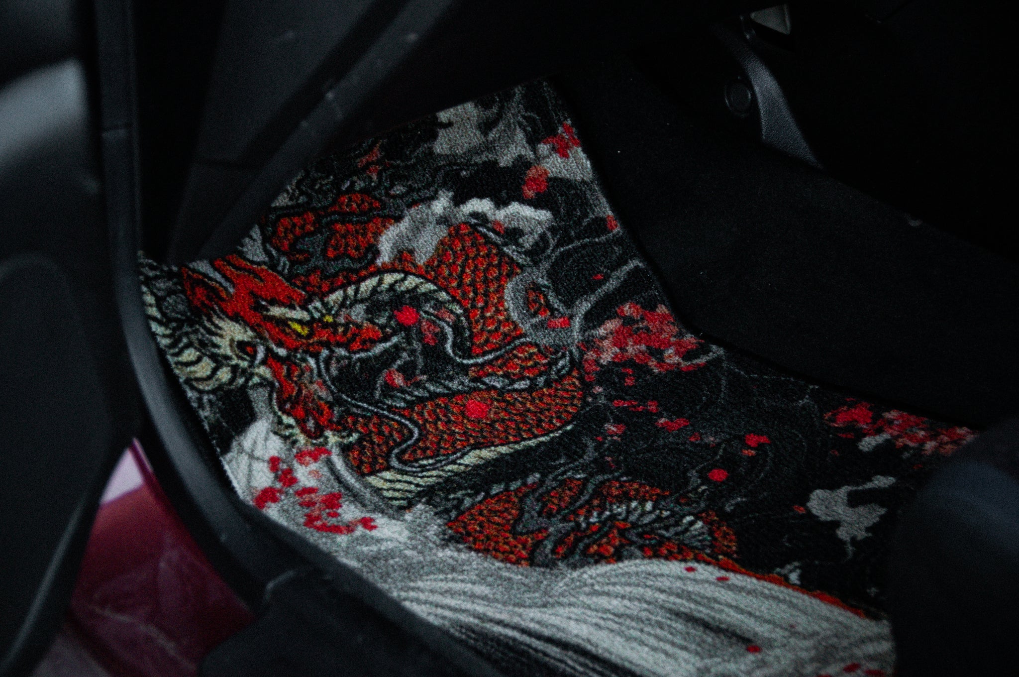 The Dragon x Koi Floor Mats by Incompletegl boast a detailed red and black dragon design. The swirling patterns and red accents evoke the mythical allure of Dragon's Gate, resulting in a dynamic and intricate appearance that is sure to captivate attention.