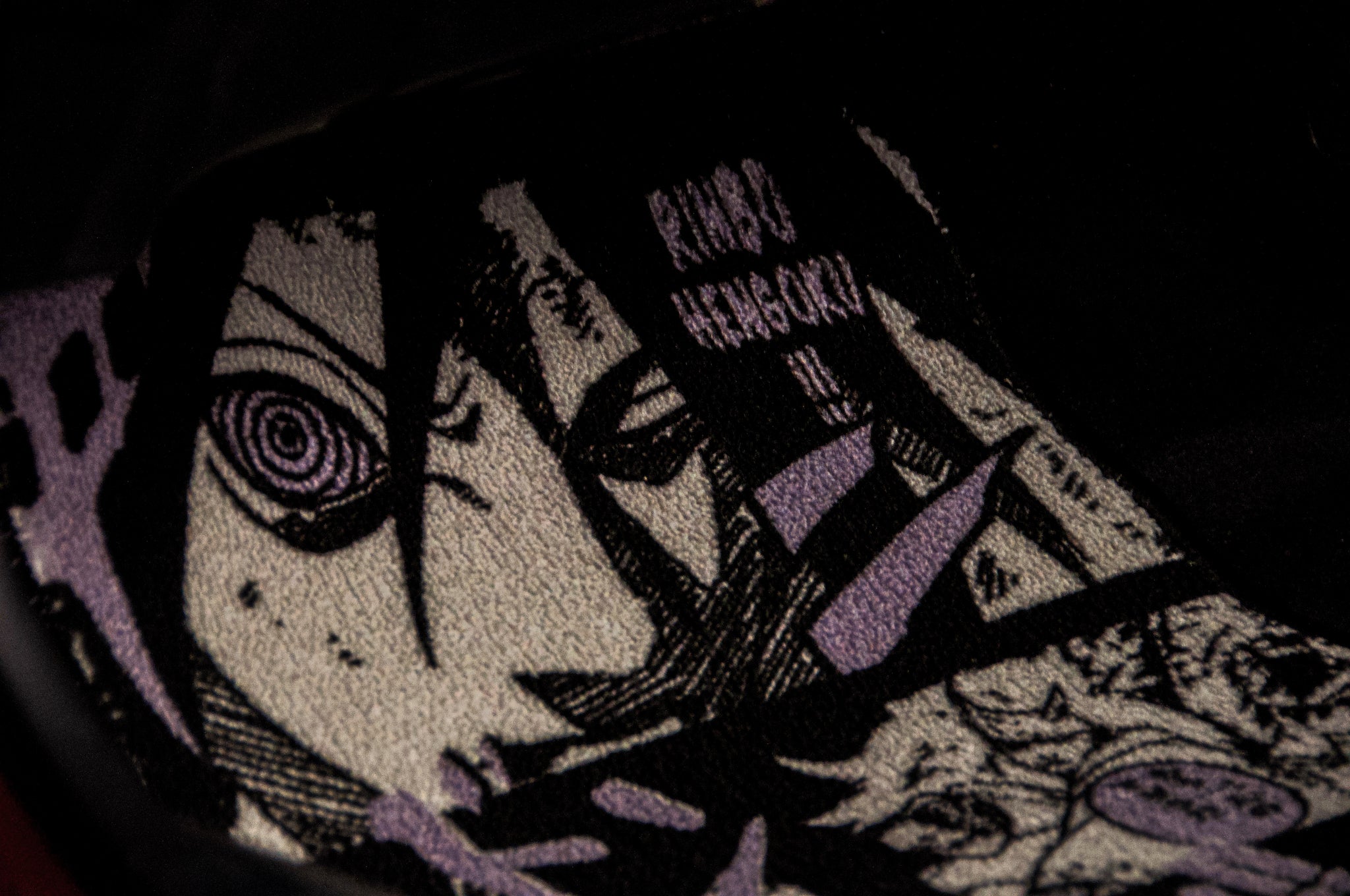 Close-up of the Rinnegan Manga Panel!! | Floor Mats by Incompletegl, featuring a textured design with a monochromatic drawing of an anime/manga character with intense eyes reminiscent of the Rinnegan. The intricate linework is set against a dark background with purple accents and partial text in the upper section, making it perfect for JDM floor mats.