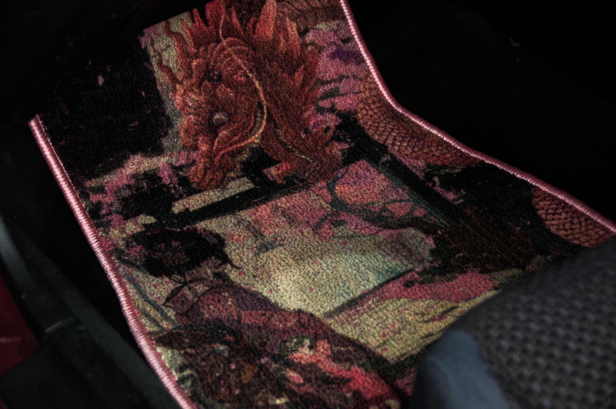 Displayed is the "Geisha x Dragon Familiar! | Floor Mats" by Incompletegl, featuring a colorful and detailed dragon design in shades of red, pink, and green. The intricately woven dragon artwork showcases Japanese art style, adding a vibrant and artistic touch to the vehicle's interior.