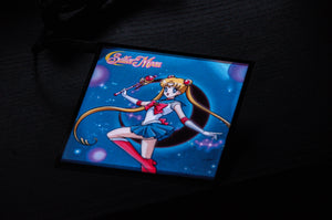 An image of the anime character Sailor Moon is vibrantly displayed on the square screen of the black Sailor Moon! | Glow Panel by Incompletegl. Sailor Moon wields a wand in her right hand, with her left arm extended, and she stands in her iconic sailor suit against a dark, starry backdrop illuminated by glowing orbs—making it an ideal JDM accessory for any car interior.