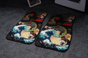 Two rectangular floor mats from the Dragon Ball Z x Ukiyo-e Style! collection by Incompletegl lie side by side on a dark carpeted floor. Evoking the style of Ukiyo-e, they feature vivid imagery of a green dragon with fiery red eyes, surrounded by swirling dark clouds above a stormy ocean scene with large waves and spray.