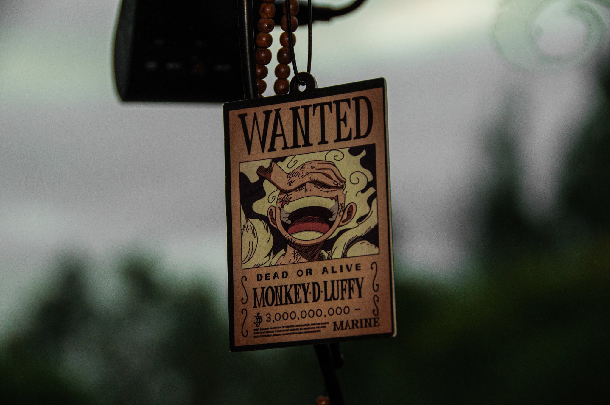 The "Luffy Gear 5 Poster! | Air Freshener" by Incompletegl features a laughing Monkey D. Luffy from One Piece in his Gear 5 form on a hanging "Wanted" poster, declaring his bounty of 3,000,000,000 berries and indicating that he's wanted dead or alive by the Marine.