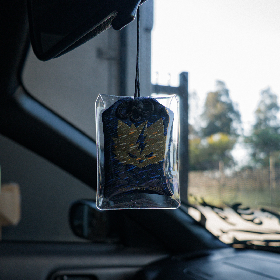 Raijū omamori charm hanging in a car – Incomplete