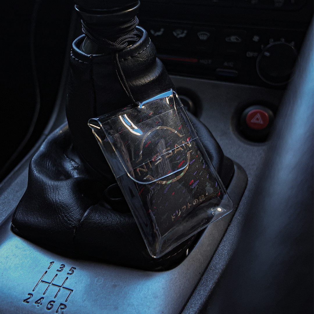 Oni omamori charm hanging in a car – Incomplete